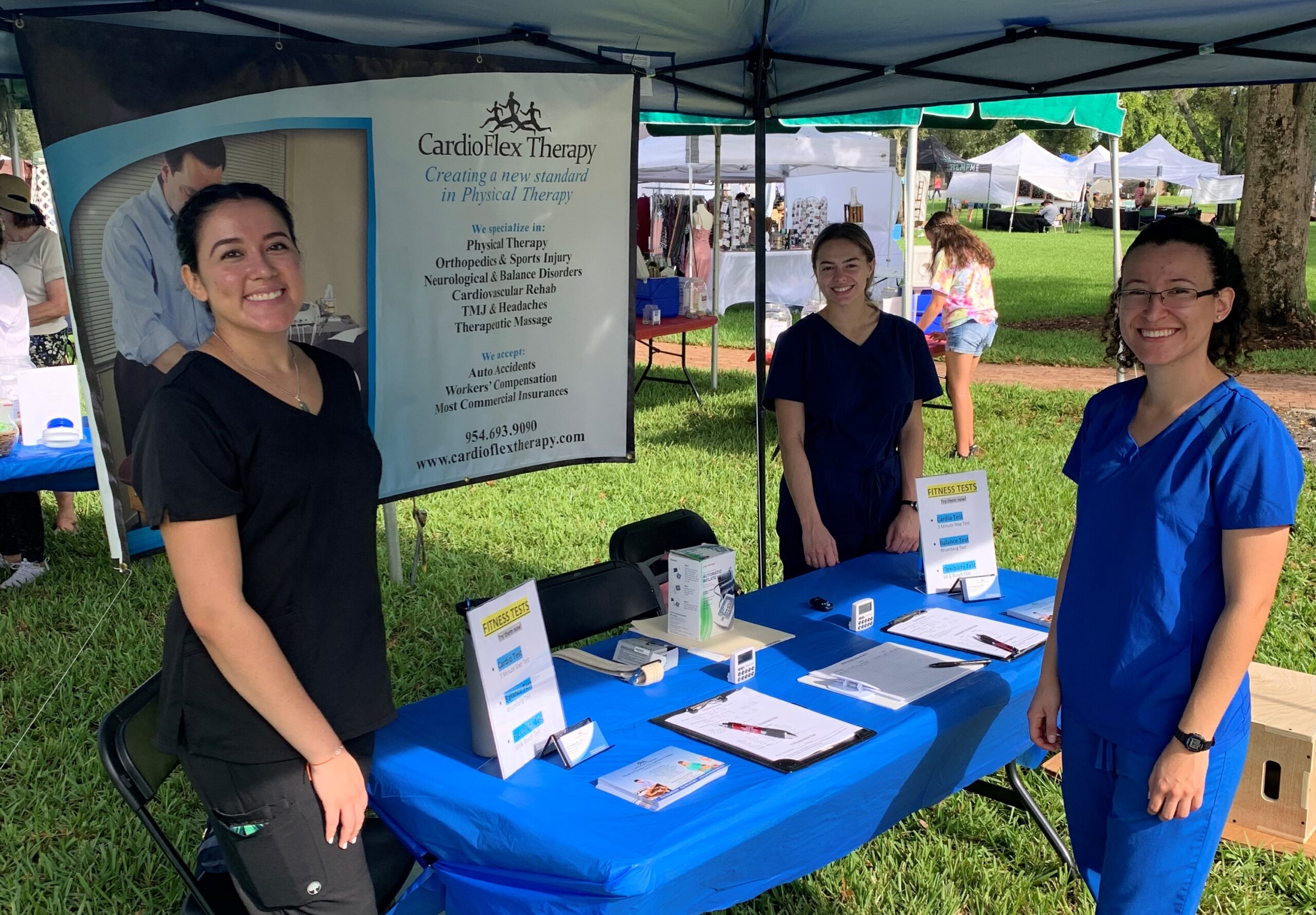 CardioFlex therapists taking a group picture during the Art in the Park event discussing their physical therapy Davie Florida services
